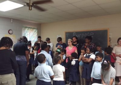 A group of people standing around in a room.