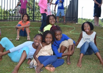 A group of children sitting on the grass.