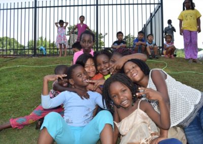 A group of children sitting on the grass.