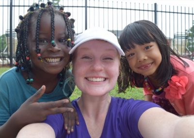 A woman taking a selfie with two young girls.