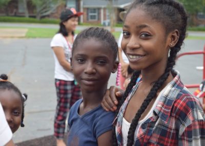 Two young girls standing next to each other.