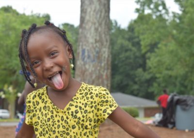 A young girl with her tongue hanging out.