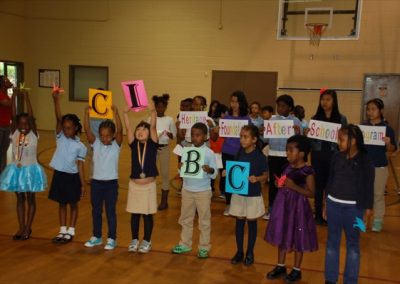 A group of children holding letters in front of them.