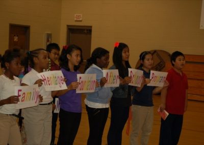 A group of children holding signs in front of them.