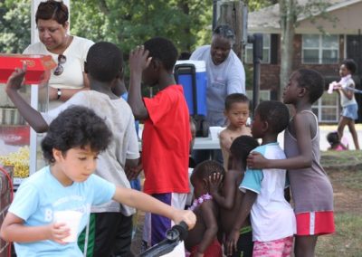 A group of children standing around each other.