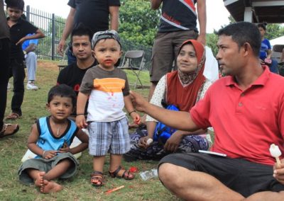 A group of people sitting around with one child.