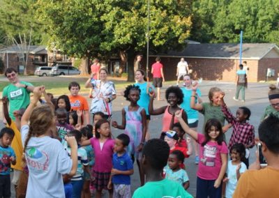 A group of children standing around in the street.