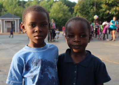 Two young boys standing next to each other.