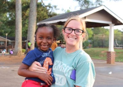 A woman holding a child in her arms.