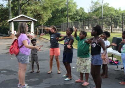 A group of people standing around in the street.