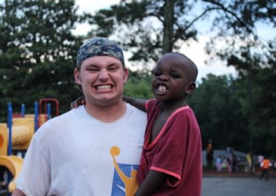 A young man and child pose for the camera.