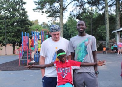 Three young men standing next to each other.