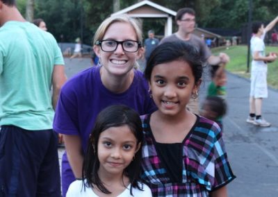 A woman and two girls posing for the camera.