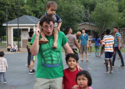 A man holding two children on his shoulders.