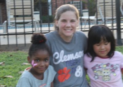 A woman standing next to two girls.