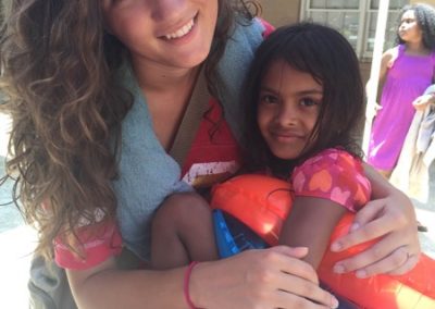 A girl and her friend are hugging each other.